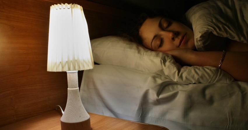 Frau schlaeft bei Licht - Im Dunkeln schlafen oder im Hellen